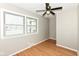 Well-lit bedroom with hardwood floors, fan, and double window offering ample natural light at 5849 Brouse Ave, Indianapolis, IN 46220