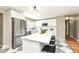 Modern kitchen boasts stainless steel appliances, large island with seating, and stylish flooring at 5849 Brouse Ave, Indianapolis, IN 46220