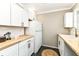 Bright kitchen with white cabinets, butcher block counters, and ample counter space at 5849 Brouse Ave, Indianapolis, IN 46220