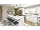 Modern kitchen boasts stainless steel appliances, large island with seating, and stylish flooring at 5849 Brouse Ave, Indianapolis, IN 46220