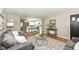 Open-concept living room connected to a modern kitchen with stainless steel appliances and island at 5849 Brouse Ave, Indianapolis, IN 46220