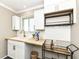 Wet bar with modern white cabinetry, butcher block counters and brushed gold hardware at 5849 Brouse Ave, Indianapolis, IN 46220