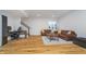 Finished basement featuring hardwood floors, a leather sofa set, a staircase, and a window providing natural light at 6027 Brentwood Trce, Brownsburg, IN 46112