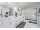 Modern bathroom with double vanity, quartz countertops, sleek black hardware, and a walk-in glass shower at 6027 Brentwood Trce, Brownsburg, IN 46112