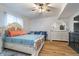 Inviting bedroom with a ceiling fan, wood floors, and a decorative bed with a cushioned headboard at 6027 Brentwood Trce, Brownsburg, IN 46112