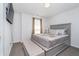 Neutral bedroom features grey decor, including a plush bed, a cushioned bench, and soft window lighting at 6027 Brentwood Trce, Brownsburg, IN 46112