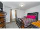Cozy bedroom featuring a leather sleigh bed with vibrant pink pillows, wooden dresser and a carpeted floor at 6027 Brentwood Trce, Brownsburg, IN 46112