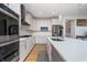 The kitchen boasts stainless appliances, a white backsplash and a modern vent hood at 6027 Brentwood Trce, Brownsburg, IN 46112