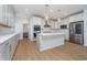 A modern kitchen features a large center island and stainless steel appliances at 6027 Brentwood Trce, Brownsburg, IN 46112