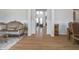 Elegant living room with hardwood floors, paneled columns, and luxury furnishings at 6027 Brentwood Trce, Brownsburg, IN 46112