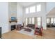Expansive living room with soaring windows, a stone fireplace, and comfortable seating at 6027 Brentwood Trce, Brownsburg, IN 46112