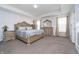 Bright main bedroom featuring an ornate bed frame, tray ceiling, and matching dressers for a luxurious feel at 6027 Brentwood Trce, Brownsburg, IN 46112