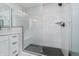 Modern bathroom with a spacious walk-in shower featuring sleek black hardware and black-tiled floors at 6027 Brentwood Trce, Brownsburg, IN 46112