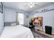Bedroom with a desk, bed, ceiling fan, and window to provide natural light at 6036 Maple Forge Cir, Indianapolis, IN 46254