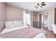 Cozy bedroom featuring hardwood floors, a ceiling fan, and a mirrored closet at 6036 Maple Forge Cir, Indianapolis, IN 46254