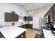 Well-lit kitchen with white countertops, dark cabinets, and modern appliances at 6036 Maple Forge Cir, Indianapolis, IN 46254