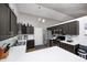Functional kitchen featuring dark cabinets, white countertops, and efficient stainless appliances at 6036 Maple Forge Cir, Indianapolis, IN 46254