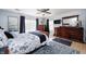 Primary bedroom with hardwood floors, ceiling fan, and ample closet space at 6036 Maple Forge Cir, Indianapolis, IN 46254