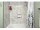 Close-up of shower-tub combo with marble-look surround and neutral toned paint at 6036 Maple Forge Cir, Indianapolis, IN 46254