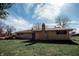 Back of house with brick chimney and nice backyard, creating a serene and private outdoor retreat at 6315 S Keystone Ave, Indianapolis, IN 46227