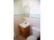 A standard full bathroom showcasing a tiled wall, vanity, and toilet at 6315 S Keystone Ave, Indianapolis, IN 46227