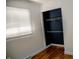 A closet with shelves and a wooden floor is lit by the light from a window in the room at 6315 S Keystone Ave, Indianapolis, IN 46227