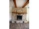 Close-up of the stone fireplace featuring a wooden mantel at 6315 S Keystone Ave, Indianapolis, IN 46227