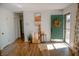 Bright foyer with wood flooring, a charming green front door, and stylish decor at 6315 S Keystone Ave, Indianapolis, IN 46227