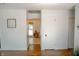 Bright hallway with white walls and wood flooring, leading to a sunlit room at 6315 S Keystone Ave, Indianapolis, IN 46227