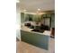 Well-lit kitchen boasts updated stainless steel appliances, green cabinets, and a modern countertop at 6315 S Keystone Ave, Indianapolis, IN 46227