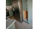 Well lit kitchen with stainless steel refrigerator and newly tiled floors at 6315 S Keystone Ave, Indianapolis, IN 46227