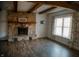 Cozy living room featuring a stone fireplace, wood floors, and a large window at 6315 S Keystone Ave, Indianapolis, IN 46227