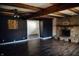 Spacious living room with wood floors, wood beams, and a stone fireplace at 6315 S Keystone Ave, Indianapolis, IN 46227