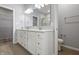 Bathroom featuring double vanity, quartz countertop, large mirror, and views to the shower and walk-in closet at 6672 Eagles Nest Ln, McCordsville, IN 46055