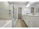 Bright bathroom with double vanity, quartz countertop, and a separate glass enclosed shower and soaking tub at 6672 Eagles Nest Ln, McCordsville, IN 46055