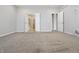 Spacious bedroom with neutral carpet and paint, featuring walk-in closet and ensuite bathroom entrances at 6672 Eagles Nest Ln, McCordsville, IN 46055