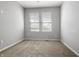 Bedroom with neutral carpet and paint, featuring dual windows and neutral blinds at 6672 Eagles Nest Ln, McCordsville, IN 46055