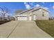 Spacious three-car garage showcasing a long driveway and well-maintained landscaping at 6672 Eagles Nest Ln, McCordsville, IN 46055