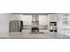 Modern kitchen with stainless steel appliances, granite countertops, and ample storage space at 6672 Eagles Nest Ln, McCordsville, IN 46055