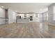 Bright, open-concept living space flowing into a modern kitchen with stainless steel appliances at 6672 Eagles Nest Ln, McCordsville, IN 46055