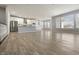 Open-concept living room and kitchen featuring stainless steel appliances and hardwood floors at 6672 Eagles Nest Ln, McCordsville, IN 46055