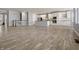 Open-concept living area featuring hardwood floors, neutral paint, and abundant natural light at 6672 Eagles Nest Ln, McCordsville, IN 46055