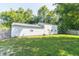 View of the exterior of the property from backyard featuring well-maintained lawn and a shed in a serene setting at 7372 Deerfield Dr, Greenfield, IN 46140