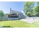 Spacious backyard features a covered patio, fenced pool, and ample space for outdoor entertaining at 7372 Deerfield Dr, Greenfield, IN 46140