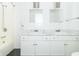 Bright bathroom featuring double sinks, white cabinetry, marble countertop, and shower-tub combination at 7372 Deerfield Dr, Greenfield, IN 46140