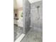 Modern tiled bathroom featuring a luxurious walk-in shower, separate tub, and a window letting in natural light at 7372 Deerfield Dr, Greenfield, IN 46140