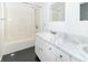 Well-lit bathroom features double sinks, marble countertop, white cabinets, and shower-tub combination at 7372 Deerfield Dr, Greenfield, IN 46140
