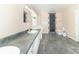 Stylish bathroom featuring a sleek vanity, grey tile flooring, and a modern tiled shower at 7372 Deerfield Dr, Greenfield, IN 46140