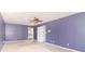 Spacious bedroom features ceiling fan, blue walls and natural light, ready for customization at 7372 Deerfield Dr, Greenfield, IN 46140