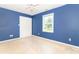 A brightly colored bedroom with a ceiling fan and a window with a nice view of the property at 7372 Deerfield Dr, Greenfield, IN 46140